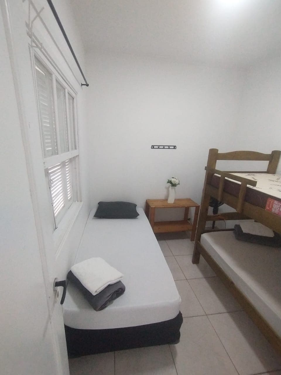 Quarto mobiliado com camas e mesa lateral